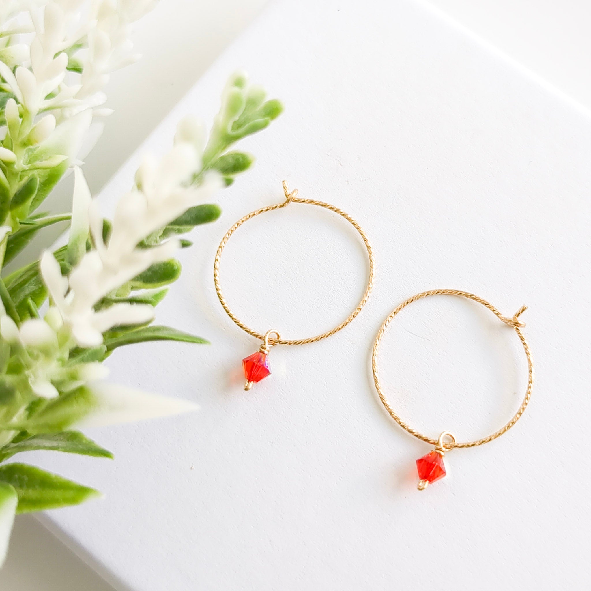 Gold hoop earrings with orange drop