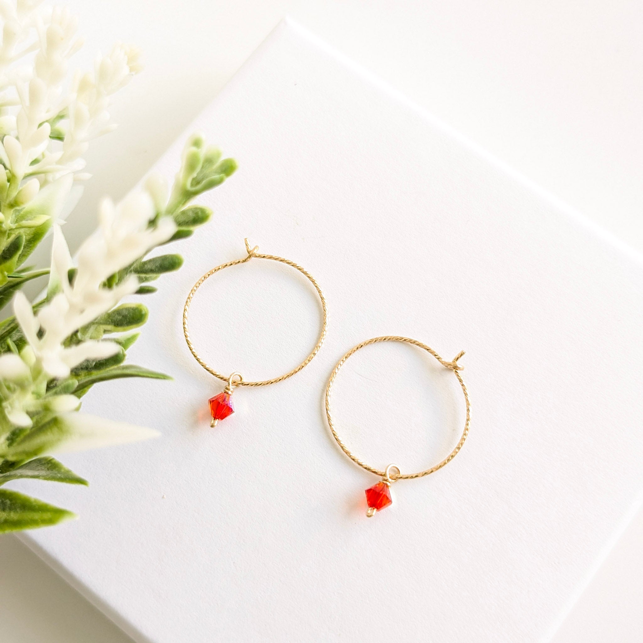 Gold hoop earrings with orange drop