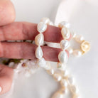 Baroque pearl necklace in hand