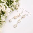 long earrings with 3 irregular shaped pearls attached with sterling silver wire and a sterling silver earring hook